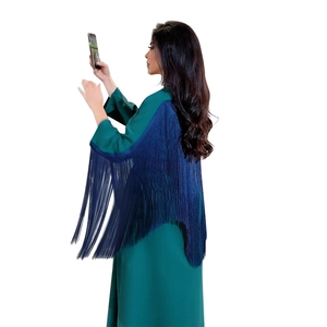 Detail of emerald green kaftan abaya featuring navy blue fringe tassels on back and sleeves