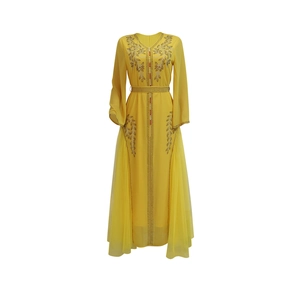 Detail of yellow tulle kaftan dress showing intricate sequin floral beadwork on the chest