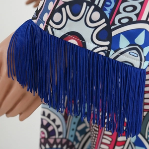 Détail de la manche à imprimé bohème avec de longues franges bleu roi et motifs géométriques