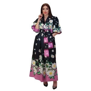 Detail of floral print maxi dress with puff sleeves and waist tie on black and pink base