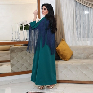 Elegant emerald green long-sleeve maxi dress featuring dark blue fringe details on sleeves