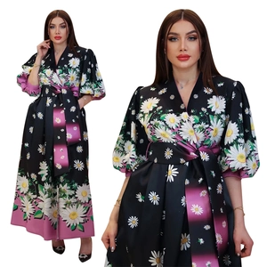 Detail of floral print maxi dress with v-neck design and purple striped hem accents