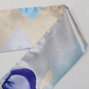 Detail of satin fabric with abstract digital print in purple and blue shades