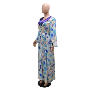 Close-up of the elegant floral print and V-neck detail on this yellow satin maxi dress