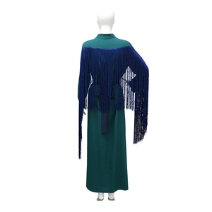 Detail of dark blue rhinestone fringes and green chiffon fabric on the long kaftan dress