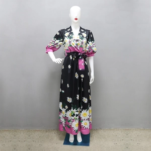 Detail view of V-neck printed long dress with floral daisy pattern and pink accents