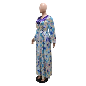 Detail of floral print maxi dress with purple V-neckline and decorative blue beads