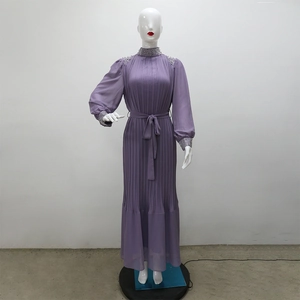 Détail de robe longue plissée violette avec strass sur le col et les poignets