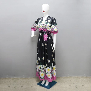 Detail of floral print maxi dress featuring V-neck and puff sleeves on mannequin