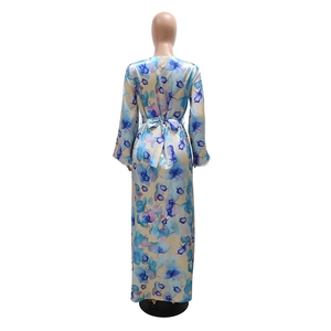 Rear view of floral print maxi dress with long sleeves and elegant waist tie belt