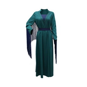 Detail of V-neck pattern and long blue fringes on a dark green modest maxi dress