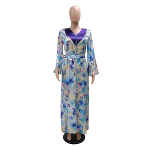 Detailed view of bohemian floral maxi dress with V-neckline and decorative buttons
