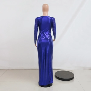 Detail of dark blue metallic dress featuring sheer mesh sleeves with sparkling rhinestones
