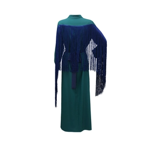 Back view of dark green maxi dress with vibrant blue tassel trim on sleeves