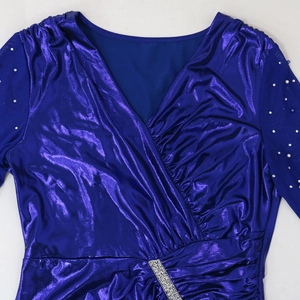 Detail of royal blue V-neck evening gown with sparkling silver waist buckle and pearl mesh