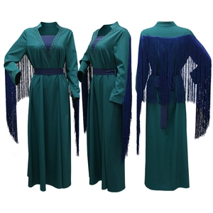 Detail view of dark teal maxi dress featuring long blue tassels and rhinestone V-neckline
