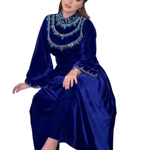 Deep blue velvet kaftan gown featuring green crystal drops and silver embroidery details