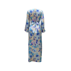 Rear view of long-sleeved floral print robe with elegant silk-like texture and waist tie
