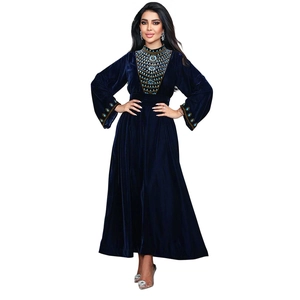 Intricate turquoise beading and gold embroidery details on navy velvet maxi dress