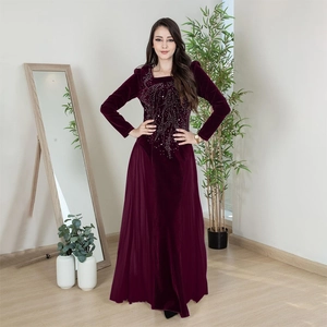 Detailed view of the sparkling rhinestone branch pattern on the velvet evening gown
