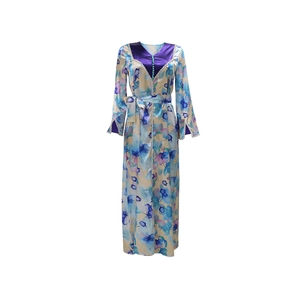 Close-up of contrast V-neckline with decorative buttons on floral print kaftan dress