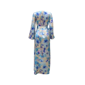 Detail of champagne satin floral dress showing orchid print and delicate lace cuffs