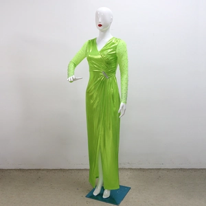 Detail of lime green evening gown with sheer mesh sleeves and sparkling rhinestone embellishments
