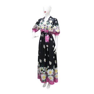 Detail of V-neckline and daisy print on midi dress with contrast pink trim and waist tie