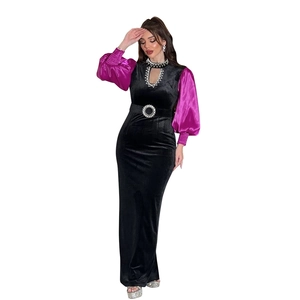 Detail of velvet gown featuring sequin belt and purple puff sleeves on evening dress