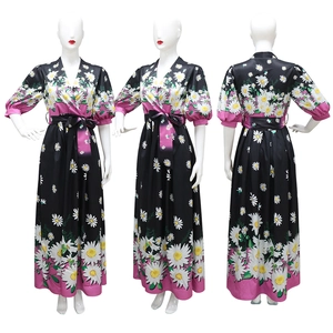 Detail view of floral maxi dress with white daisy prints and pink trim on high-quality mannequin