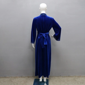 Rear view of deep blue velvet robe featuring a waist-defining tie and intricate beadwork