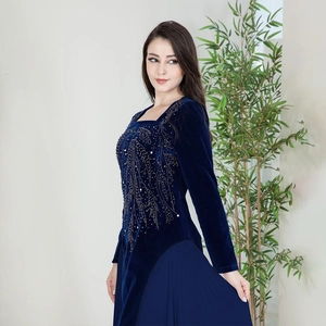 Detail of navy velvet evening dress with sparkling rhinestones and pleated chiffon skirt