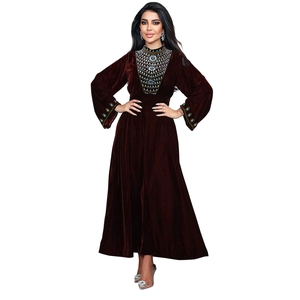 Detailed embroidery with blue and gold beads on a deep burgundy velvet evening gown