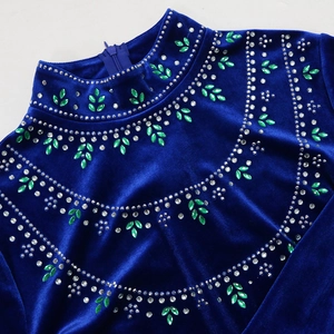 Detail of emerald leaf rhinestones and hidden zipper on royal blue velvet robe dress