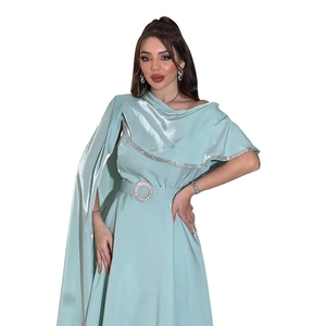 Detail of mint green satin gown featuring rhinestone belt buckle and sequin trim edges