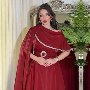 Detailed view of burgundy satin gown with rhinestone trim on cape and jeweled belt buckle