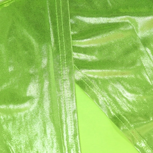 Macro shot of metallic fluorescent green evening gown fabric with detailed stitching
