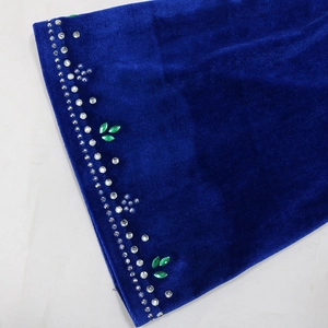 Detail view of velvet robe showing hand-set silver rhinestones and green leaf sequins