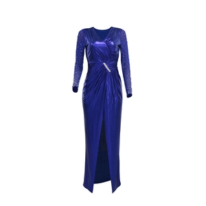 Detail of navy evening gown featuring crystal waist embellishment and sheer sequined sleeves