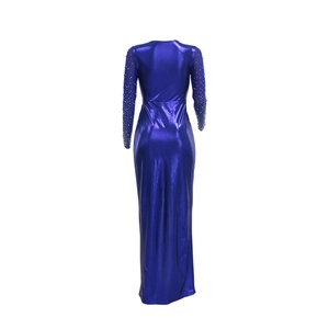 Detail of blue evening gown featuring sheer mesh sleeves with white pearls and sequins