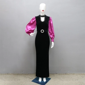 Close-up of velvet gown featuring contrast satin puff sleeves and crystal-encrusted collar