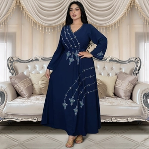 Detail of V-neck dark blue Abaya dress with green and white floral embroidery details