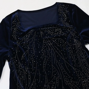 Detail of square neckline on navy velvet gown featuring silver leaf rhinestone patterns