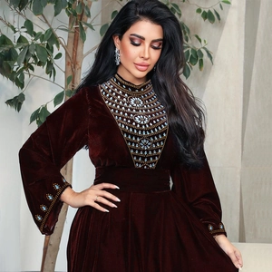Close-up of luxury dark red velvet dress featuring intricate silver beaded embroidery
