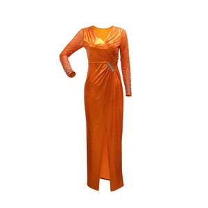 Detail of metallic orange evening gown showing waist wrap, rhinestone buckle, and high slit