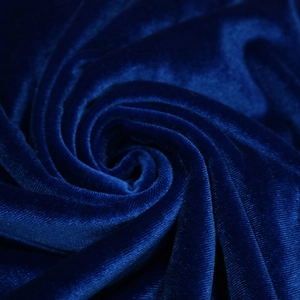 Detailed macro view of high-quality dark blue velvet fabric with rich texture and sheen