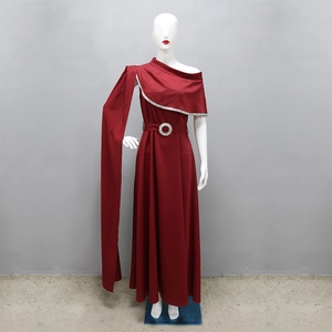 Detail of red one-shoulder evening gown featuring crystal trim and long shoulder sash