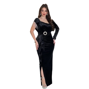 Detail of black velvet gown featuring a rhinestone buckle and side ruffle drape design