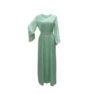 Détail de la robe en mousseline vert menthe avec strass argentés et décolleté en V profond