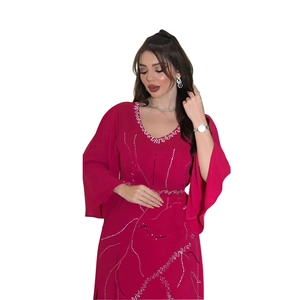 Detailed view of dark red chiffon robe dress with sparkling silver rhinestone patterns
